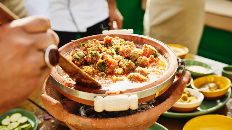 Hand stirring a Moroccan dish